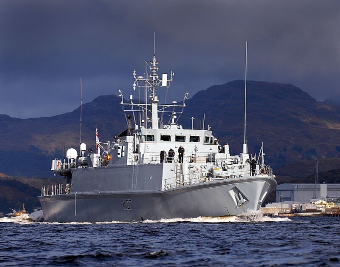 Royal Navy Sandown Class Minehunter HMS Pembroke is pictured sailing from HMNB Clyde in Western Scotland. The Class was originally named as the Single Role Minehunter and was planned to complement the capabilities of the preceding HUnt class and to be cheaper to build. Sandown MCMVs are highly manoeuvrable vessels and are considered to be the best Minehunters active in the world. Organization: Royal Navy Object Name: 04113993 Keywords: HMS Pembroke, Sandown Class, MCMV, Mine Countermeasures, Ship, Equipment, Royal Navy Country: SCOTLAND