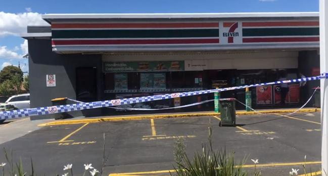 Police establish a crime scene at the 7-Eleven. 