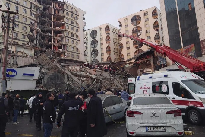 Lực lượng cứu hộ sử dụng cần cẩu để tìm kiếm nạn nhân mắc kẹt dưới đống đổ nát sau động đất tại Diyarbakir, Thổ Nhĩ Kỳ. Ảnh: AFP.