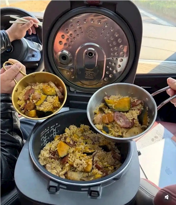 Tài xế nấu ăn trên xe trong lúc chờ đợi di chuyển. Ảnh: Sina