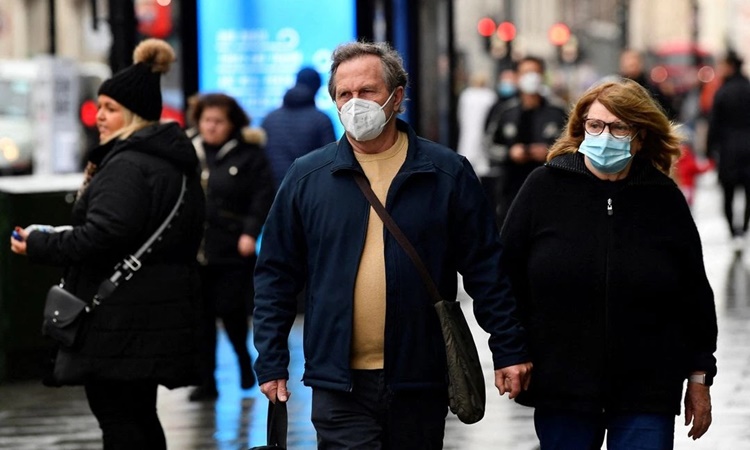 Người dân đeo khẩu trang che đi bộ trên Phố Oxford ở London, Anh, hồi cuối tháng một. Ảnh: Reuters.