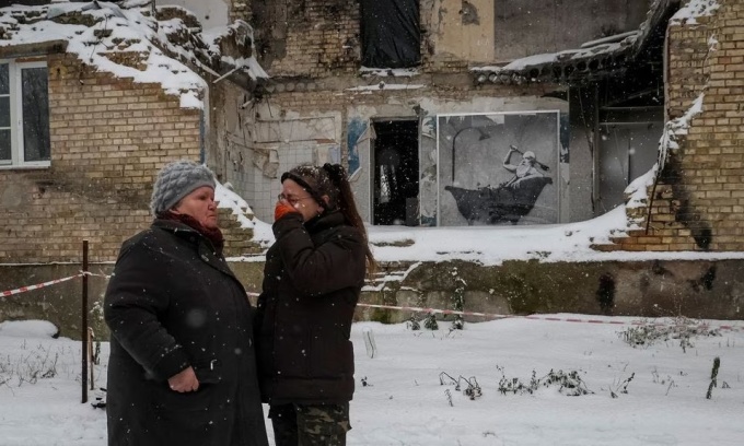 Hai cư dân ở làng Horenka, ngoại ô Kiev, đứng nói chuyện giữa trời tuyết hồi tháng 11 năm ngoái. Ảnh: Reuters.