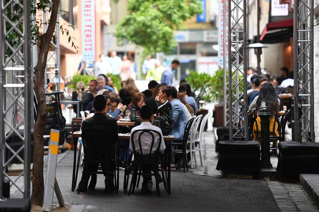 People enjoying an outside dining area in Melbourne.