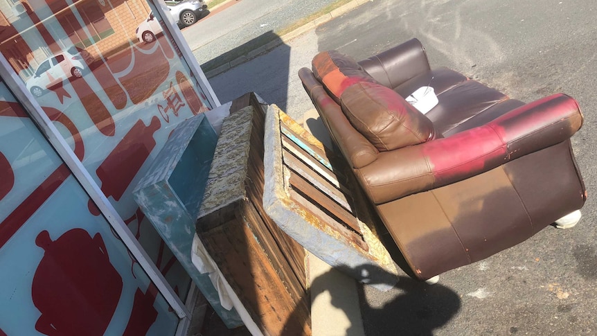 Unwanted furniture sits in op shop car park