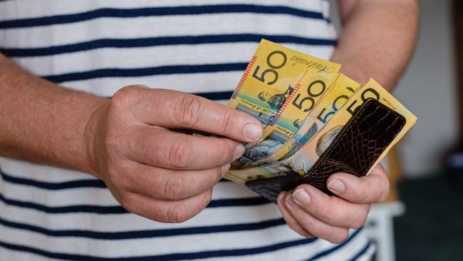 man counting Australian money