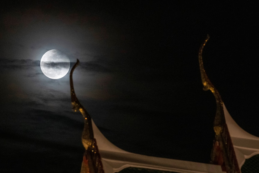 Moon amongst the clouds over Bangkok