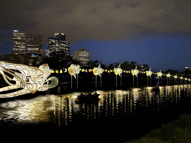 A glowing eel sculpture alongside the Yarra River