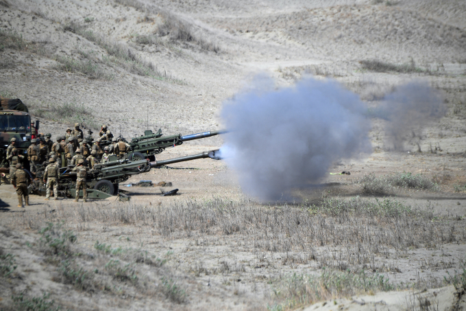 US and Philippine Marines fire M198 155mm Howitzer artillery during a live fire exercise against an imaginary invasion force as part of the joint US-Philippines annual military Balikatan drills on a strip of sand dunes in Laoag on Luzon islands northwest coast on May 6, 2024. US and Filipino troops fired missiles and artillery at an imaginary invasion force during war games on the Philippines northern coast on May 6, days after their governments objected to Chinas dangerous actions in regional waters. AFP