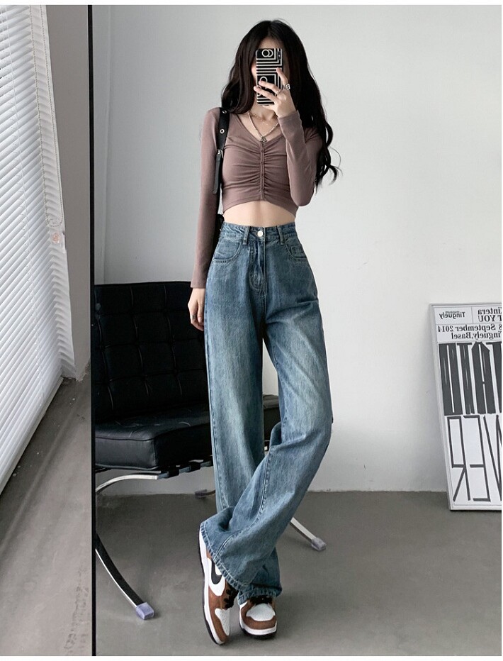 Chiếc quần jeans ống rộng cạp cao chính là nhân vật chính trong outfit này. Với chất liệu denim đứng phom, phần cạp cao giúp tôn eo và kéo dài chân, trong khi phần ống rộng tạo cảm giác thoải mái, trẻ trung.