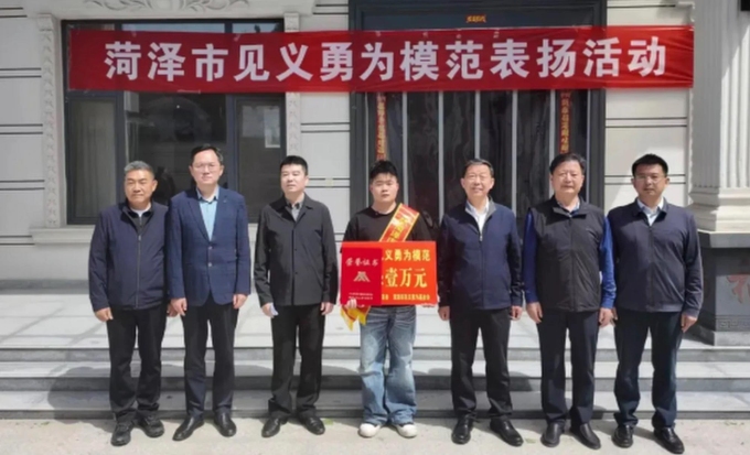Zhang (ở giữa) nhận phần thường sau khi cứu người. Ảnh: QQ