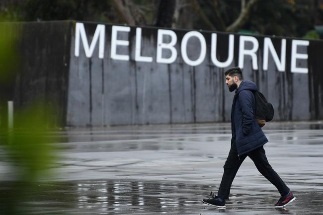 A person is seen in front of signage for the Melbourne Museum in Melbourne.
