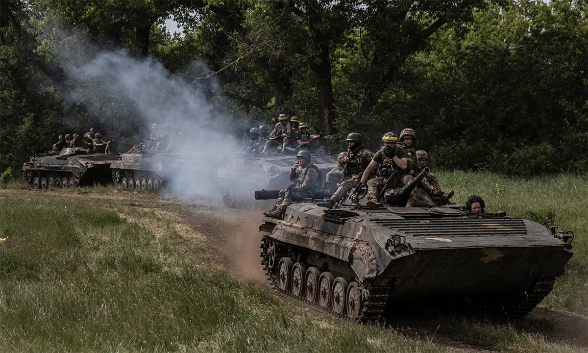 Binh sĩ Ukraine ngồi trên thiết giáp di chuyển gần thành phố Severodonetsk và Lysychansk trong ảnh công bố ngày 9/6. Ảnh: NY Times.