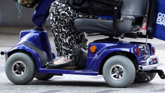 A person rides a motorised scooter