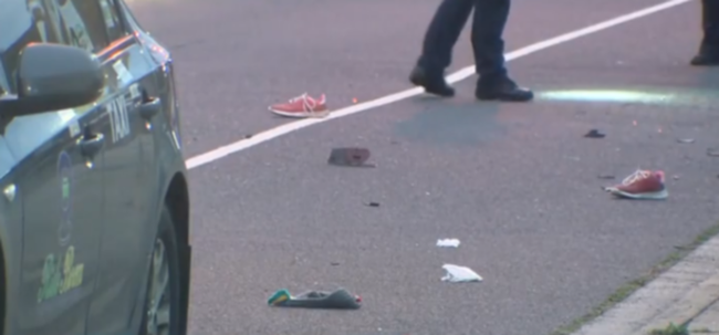 A pair of running shoes was left on the road.