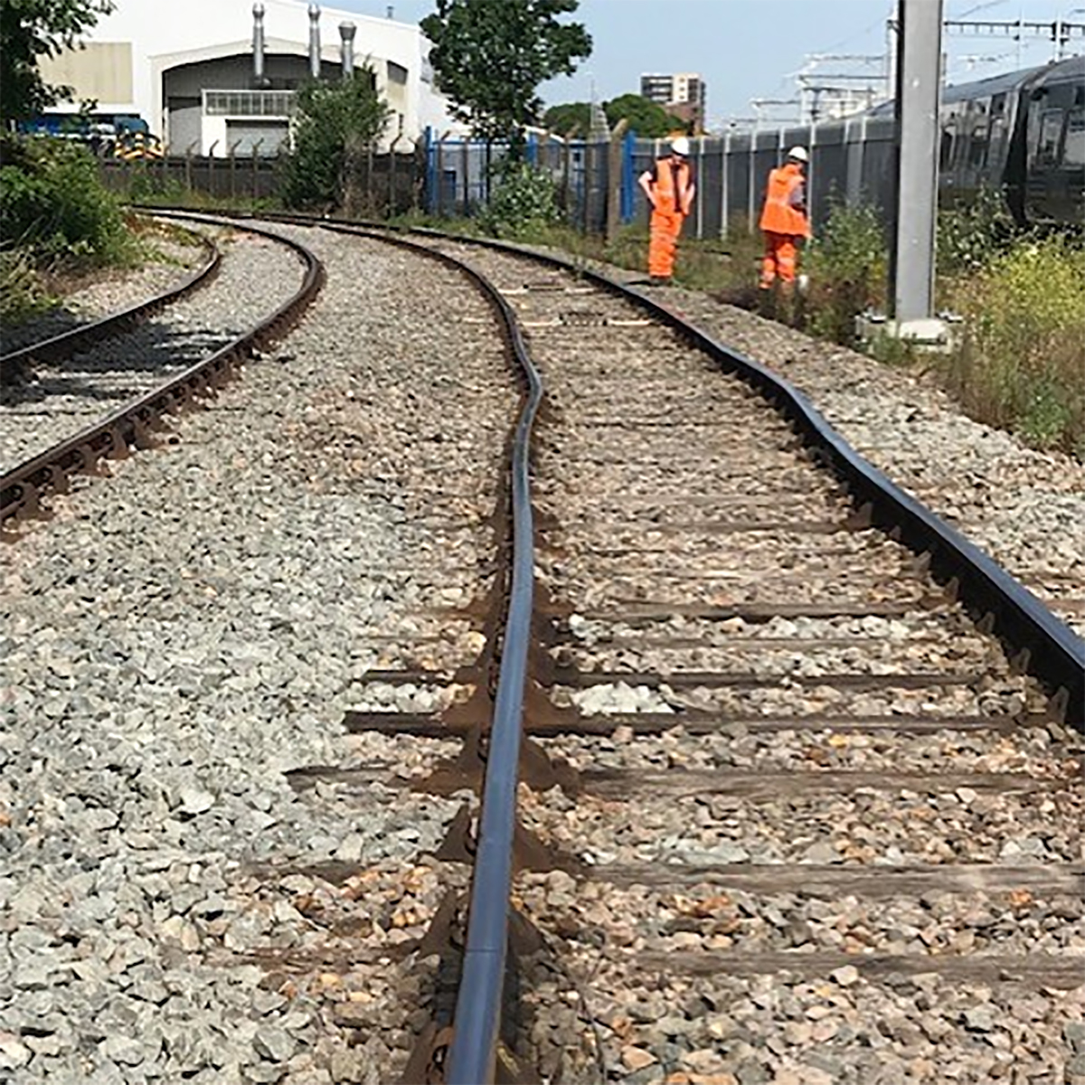 Công nhân đường sắt Anh kiểm tra một đoạn bị cong vì nhiệt độ cao trong ảnh công bố ngày 19/8. Ảnh: Network Rail.