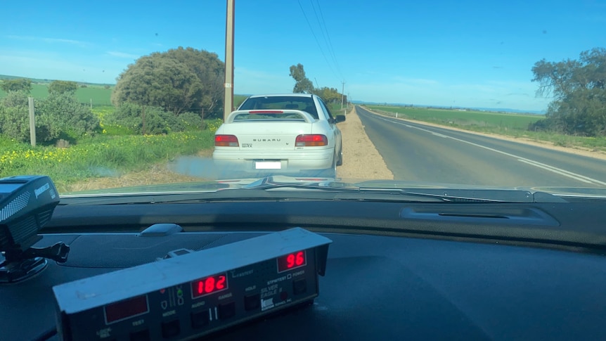 A Suburu WRX pulled over by police.