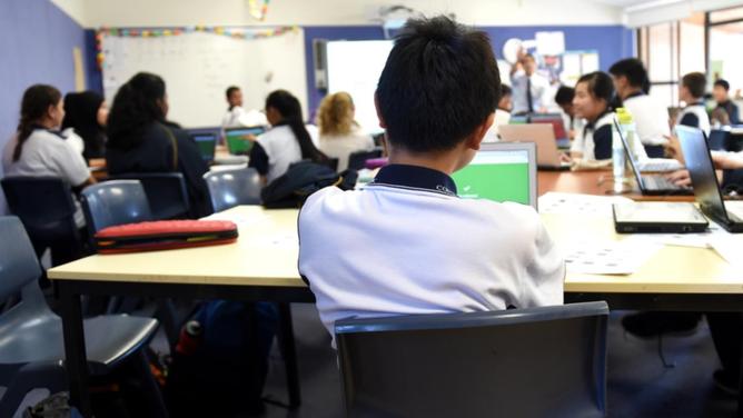 A survey of 25,000 people found 74 per cent of teachers said reducing workload would help students. (Paul Miller/AAP PHOTOS)