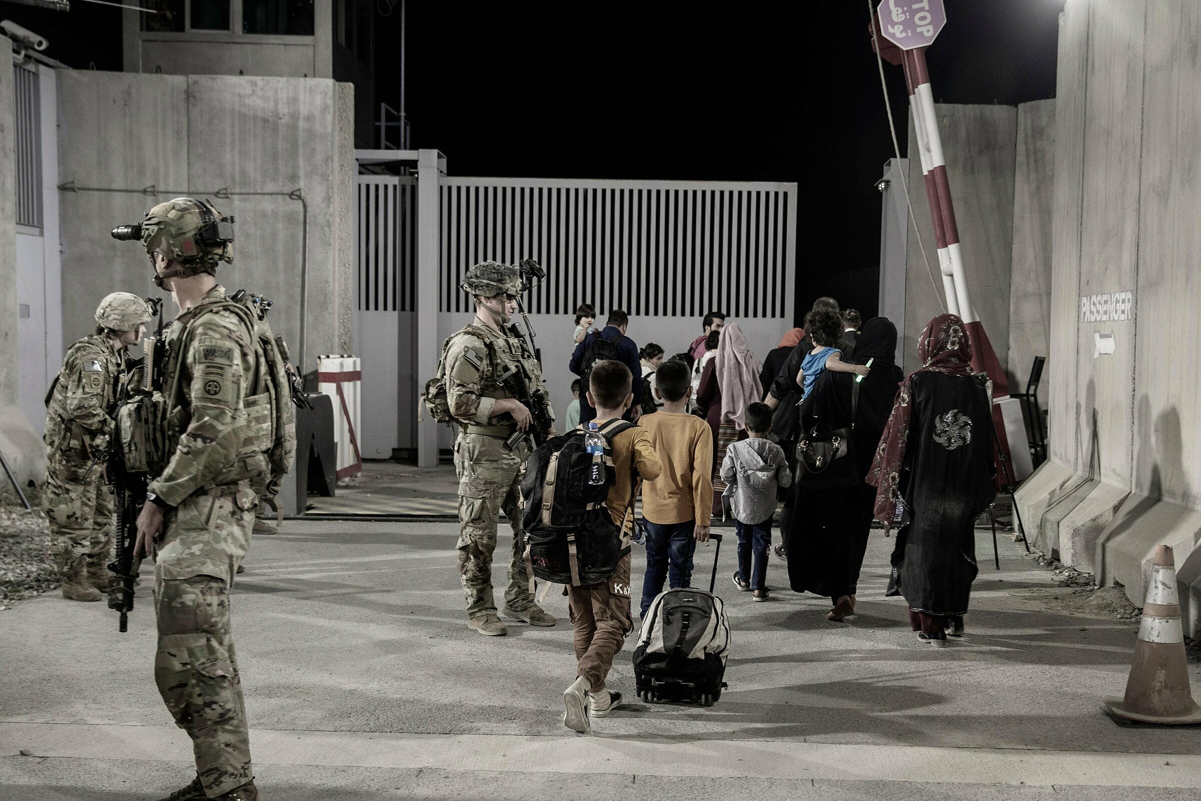 Lính thủy quân lục chiến Mỹ hướng dẫn người tị nạn qua cổng sân bay Kabul vào ngày 25/8. Ảnh: Bộ Quốc phòng Mỹ.