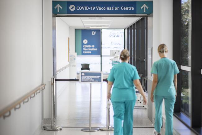 Nurses are seen walking into the Covid-19 Vaccine wing.