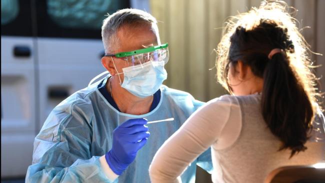 A nurse conducts coronavirus tests at a private residence in Melbourne