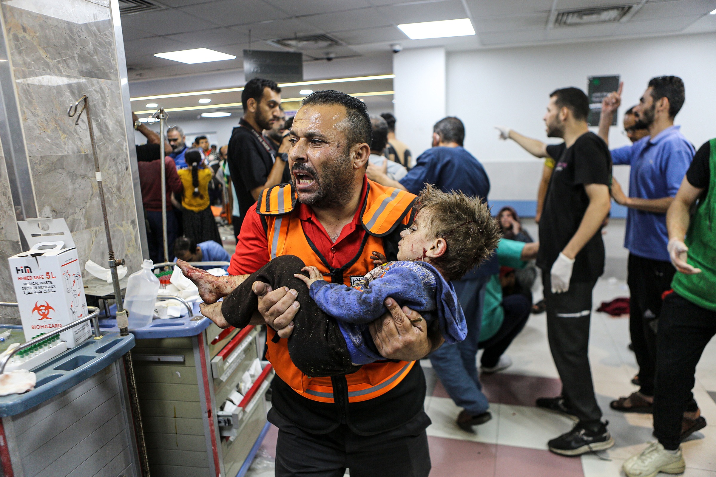 Large numbers of injured people are brought into Shifa Hospital in Gaza City after an Israeli attack on the courtyard of al-Ahli Arab Hospital. [Abdelhakim Abu Riash/Al Jazeera]