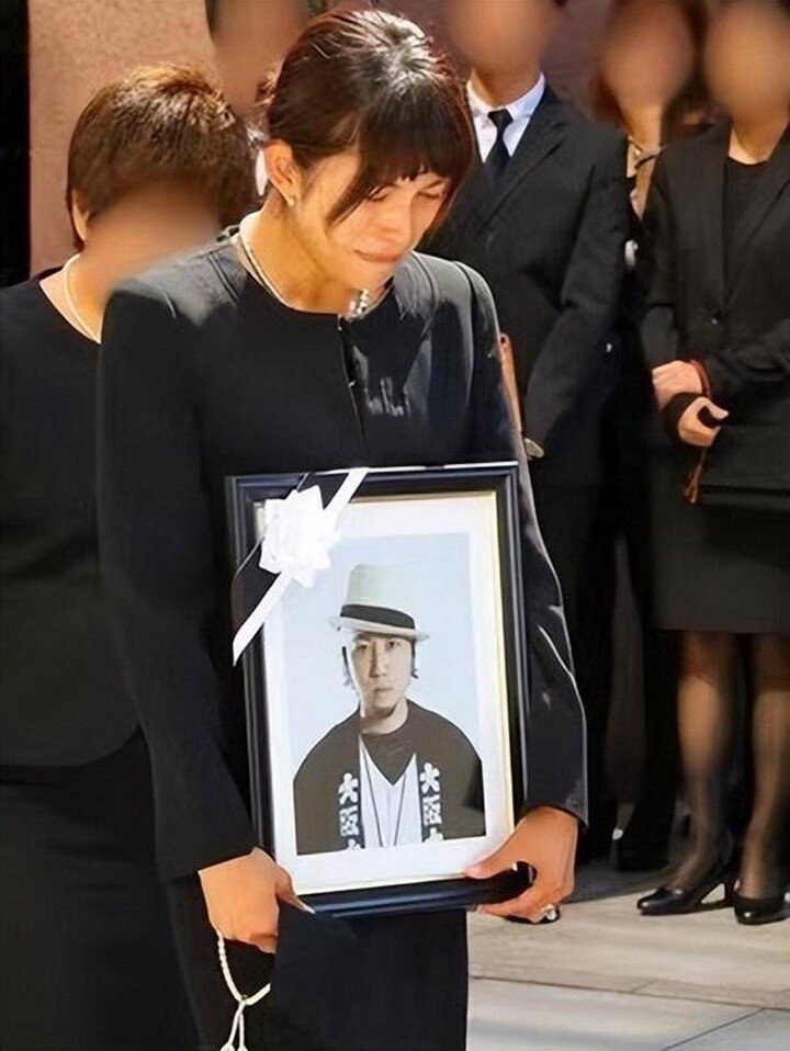 Nữ ca sĩ bật khóc khi ôm di ảnh của chồng.