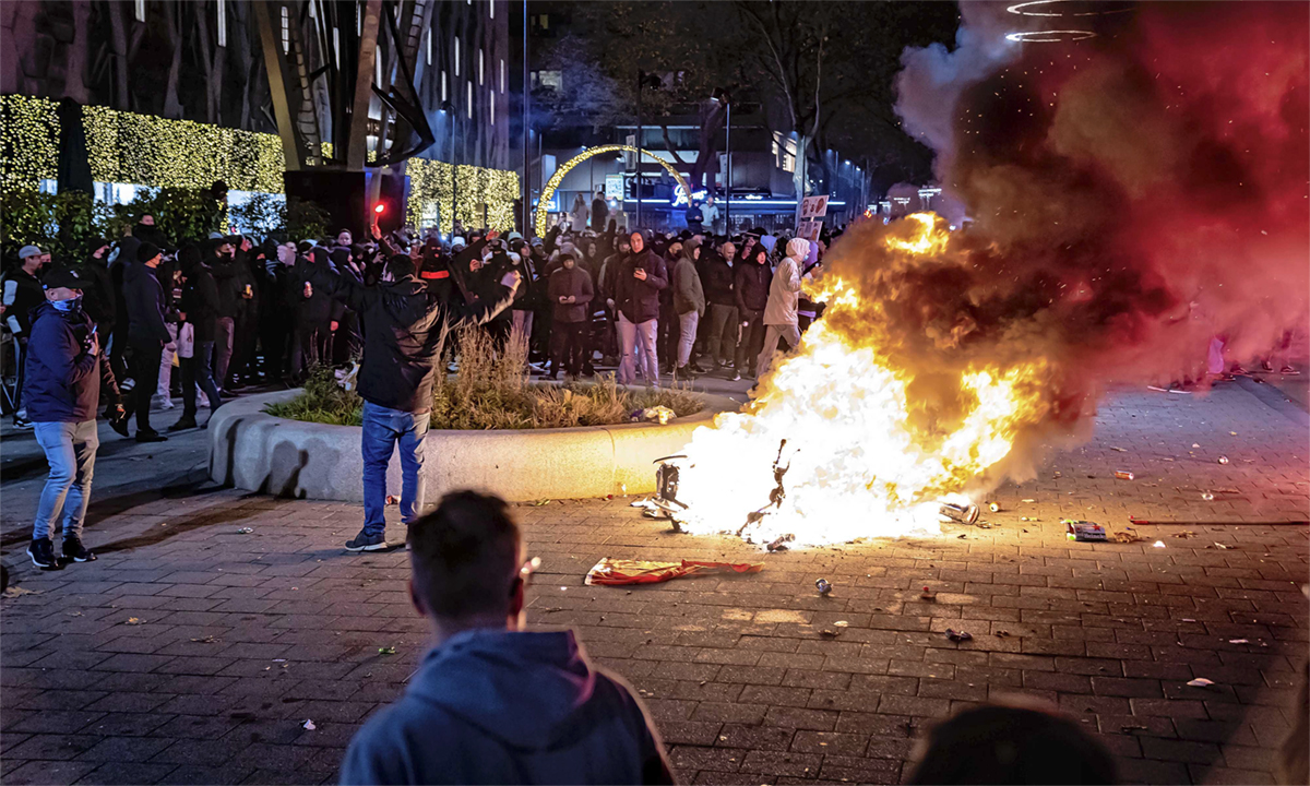 Người biểu tình đốt cháy một chiếc xe tay ga tại thành phố Rotterdam, Hà Lan ngày 19/11. Ảnh: Reuters.