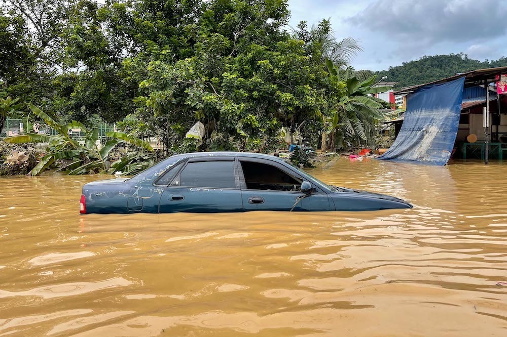 Một chiếc ôtô ngập sâu trong nước lũ ở bang Selangor, Malaysia, hôm 19/12. Ảnh: Malay Mail.