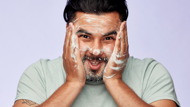 A man using face wash by the brand Stuff.