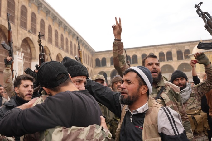 Các tay súng nổi dậy ăn mừng sau khi kiểm soát thủ đô Damascus, Syria, hôm 8/12. Ảnh: AFP