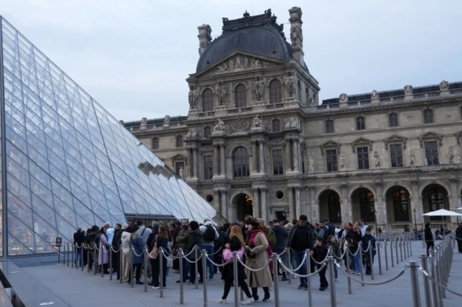 Du khách xếp hàng vào bảo tàng Louvre, Paris, sáng 22/10. Ảnh: AP