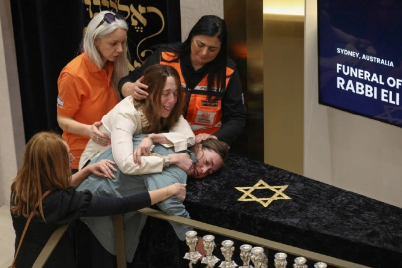 Người thân ôm quan tài của giáo sĩ Eli Schlanger trong lễ tang tại Hội đường Do Thái Chabad ở Bondi, Sydney, ngày 17/12. Ảnh: AFP